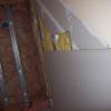 Adding in new drywall in basement landing stair landing area.